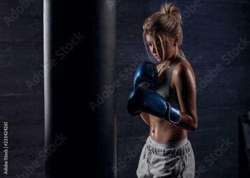 Sexy girl boxer trains in boxing hall