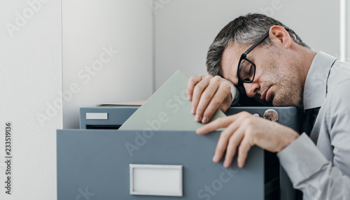 Tired office worker sleeping in the office