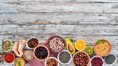 Superfoods Healthy food. Nuts, berries, fruits, and legumes. On a white wooden background. Top view. Free copy space.