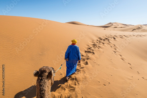 Berber nomad with a camel in Sahara desert, Morocco