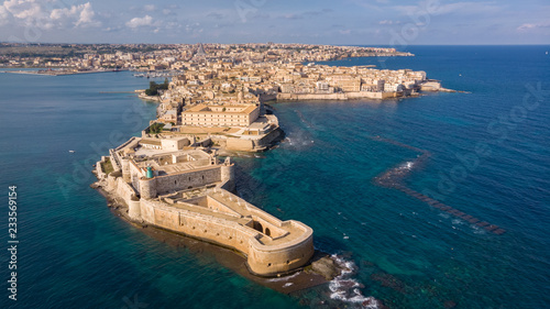 Aerial view of Ortigia, historical centre of the city of Syracuse. Aerial view of Maniace fortress in Ortigia, Sicily, Italy. Sanctuary "Our Lady of Tears" is at the background