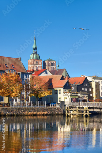 Historical houses and brick towers of Stralsund in Northern Germany with reflection