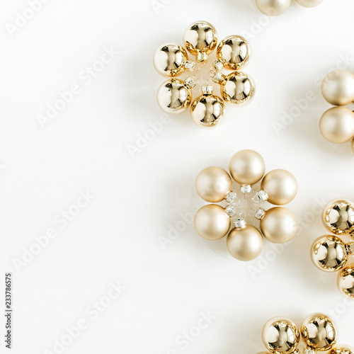 Christmas composition with golden decoration balls on white background. Flat lay, top view. Blog hero header.