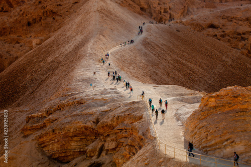 Line of tourists climbed on Masada fortrees rock. Israel.