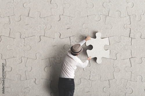 man placing the last puzzle piece 