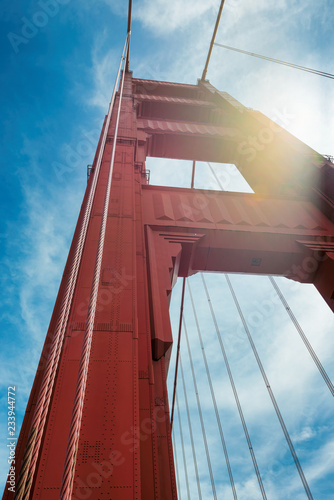 Golden Gate Bridge, perspective of tower of bridge support sunset in San Francisco, California.