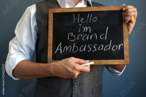 Man is holding blackboard with sign I am Brand Ambassador.