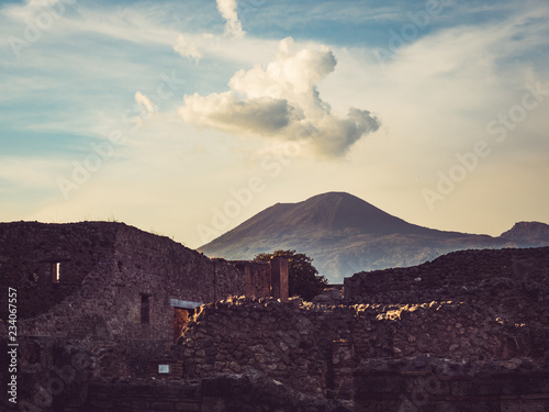 Beautiful view of the ancient city of Pompeii on the background of the volcano Vesuvius. Sunset photo. Concept of leisure and travel