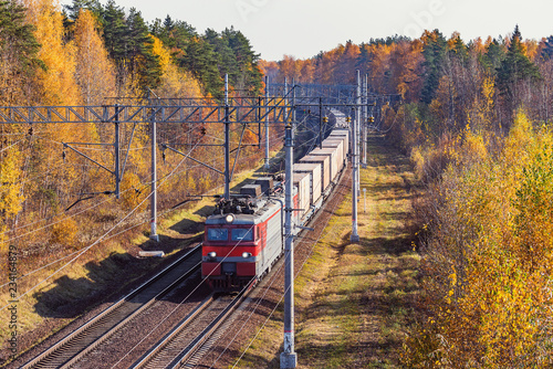 Long freight train approaches to the station.