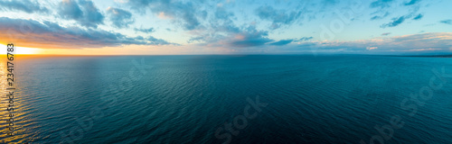 Wide aerial panorama of sunset over ocean - minimalistic seascape