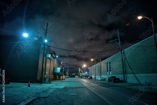 Industrial urban street city night scene with vintage factory warehouses and train tracks