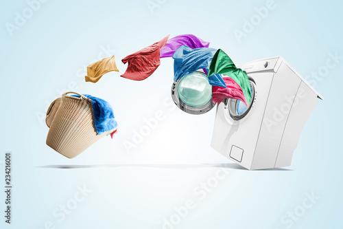 Clothing from laundry basket go into the washing machine