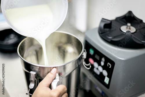 making gelato ice cream with modern equipment in kitchen interior