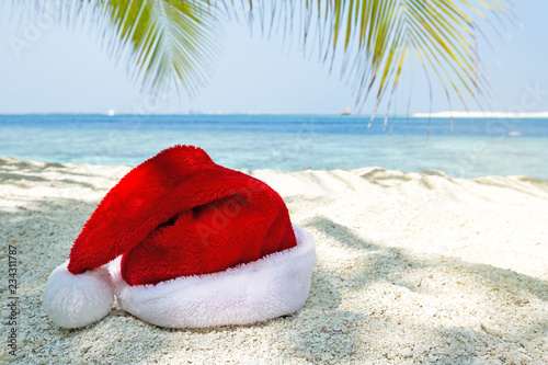 Santa Claus hat on perfect tropical beach
