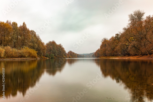 reflection of autumn forest in the river