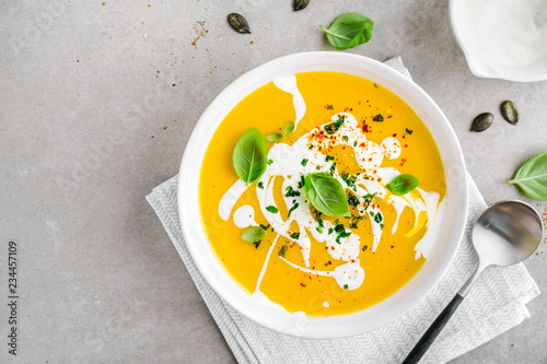 Pumpkin creamy soup served in bowl