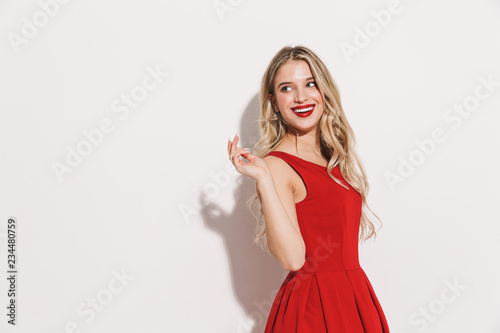 Portrait of a smiling young woman in red dress