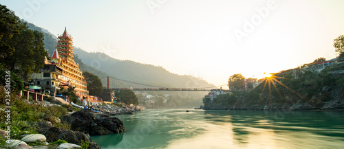 Spectacular view of the Lakshman Temple bathed by the sacred river Ganges at sunset. 