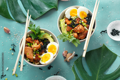 Two poke bowl fried rice chicken fillet eggs top view Asian food