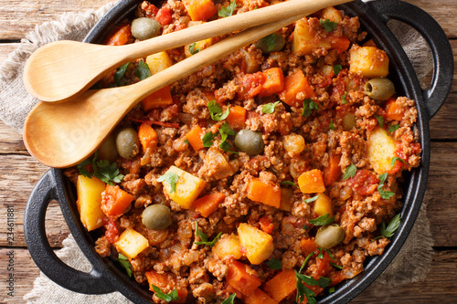 Picadillo Recipe Ground beef, carrot and potatoes cooked in a tomato sauce closeup on a pan. horizontal top view