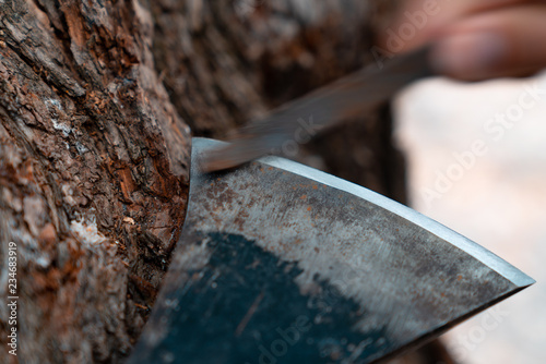 Man sharpening axe blade