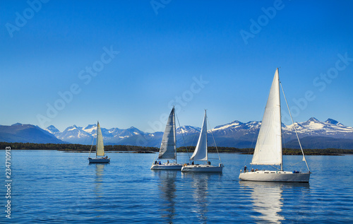 Sailboats sailing, blue cloudy sky and white sails. Molde Norway, Europe
