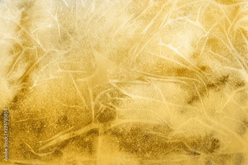 Gold luxury ink and watercolor textures on white paper background. Paint leaks and ombre effects. Hand painted abstract image.