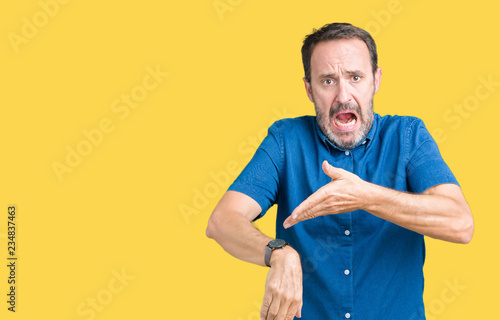 Handsome middle age elegant senior man over isolated background In hurry pointing to watch time, impatience, upset and angry for deadline delay