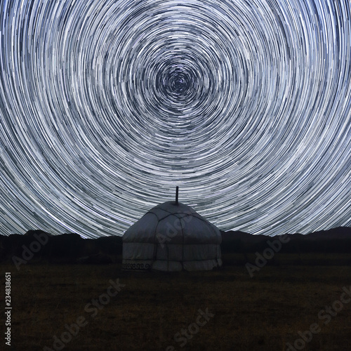 Night of star trail over yurt in the Western Mongolia