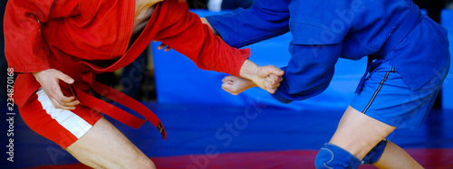 Sambo fighter attacking his opponent with leg technique
