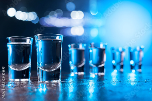 Glasses of Vodka lit with blue backlight.