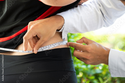 Rio de Janeiro, Brazil - november 22, 2018: health professional measuring a patient's waist