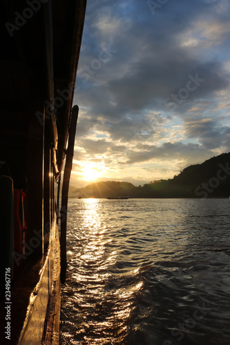Sunset cruise on the Mekong River in Luang Prabang, Laos, seen from the traditional boat