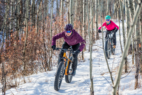 Two Women riding Fat Bikes in the Snow