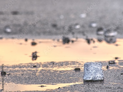 Blue and white pieces of broken ice. Melting of broken ice pieces, crushed floes