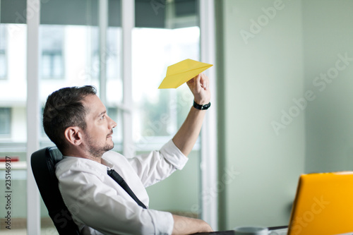 Businessman Throwing Paper Airplane