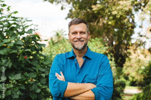 Portrait of Senior man caucasian smiling and looking at camera, outside in park.