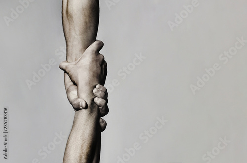 Helping hand concept and international day of peace, support. Helping hand outstretched, isolated arm, salvation. Close up help hand. Two hands, helping arm of a friend, teamwork. Black and white
