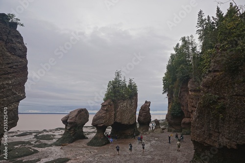Fundy National Park, New Brunswick, Canada: Tourists walk among the exposed Hopewell Rocks on the Bay of Fundy at low tide.