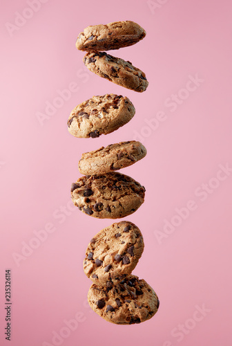 Chocolate chip cookies falling in stack