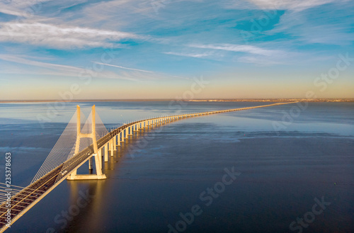 Vasco da Gama Bridge landscape at sunrise. One of the longest bridges in the world. Lisbon is an amazing tourist destination because its light, its monuments. Portugal landmark.