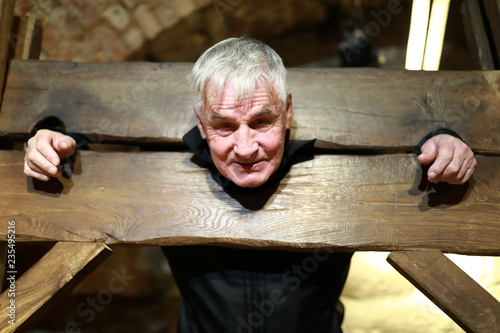 Elderly man in pillory