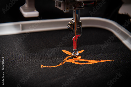 Exquisite Embroidery: Macro Shot of Orange Embroidered Design on Black Fabric