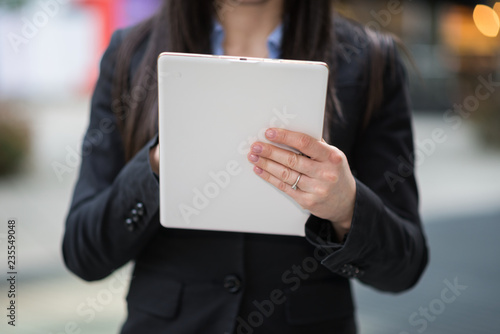 Detail of a woman using a digital tablet