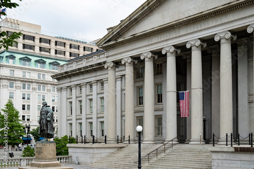 Washington DC, June 2017 United States: neoclassical style building of treasury department with Albert Gallatin statue in front of the northern entrance