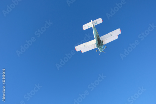 Biplane is in the blue sky.