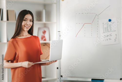 Dark-haired economist preparing monthly statistics