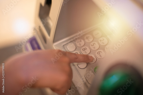 Woman is close up of hand, finger pressing keystroke cash machine, ATM banking Located in front of the bank.