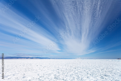 Lake Baikal in winter. Beautiful stratus clouds above the field of snowbound ice hummocks on Small Sea (Maloe More) Strait. Natural background