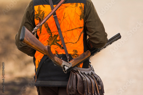 The hunter in the hunting clothes with a new hunting rifle